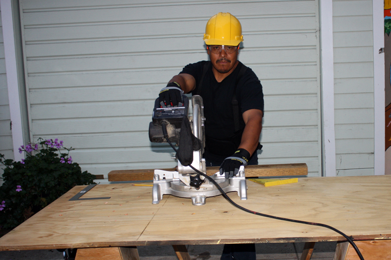 Worker at Work Table Using Radial Saw